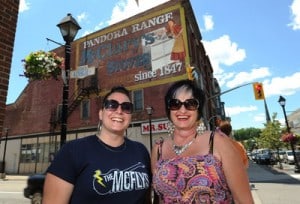 Pandora Range McClary Stoves after Project leaders in front of the repainted ghostsign in Cambridge, Ontario, Canada