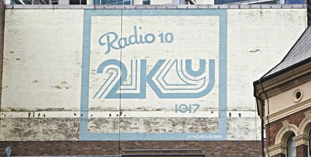 Hand painted sign in sky blue on a building advertising Radio 2KY
