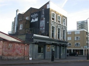 Hand-painted sign advertising Asahi beer on side wall of pub