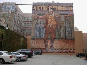 Large mural advertising the Victor Clothing Company and featuring actor Anthony Quinn