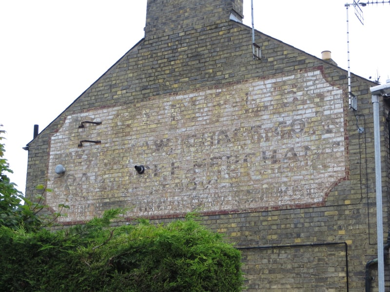 Painted sign on a wall in Cambridge