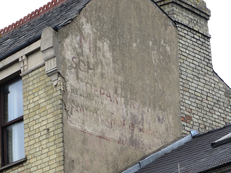 Painted sign on a wall in Cambridge