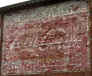 Coca Cola ghostsign by James Deans Faded hand painted sign on a wall advertising Coca-Cola
