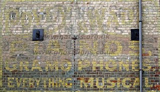 Pianos and Gramophones ghostsign by James Deans Hand painted sign on building advertising a musical shop.