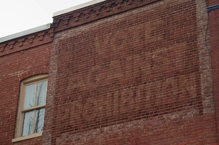 Fading hand painted sign on a building in Baltimore