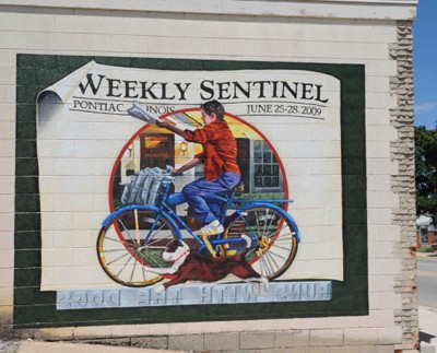 Weekly Sentinel mural in Pontiac Illinois Hand-painted mural showing paperboy for the Weekly Sentinel