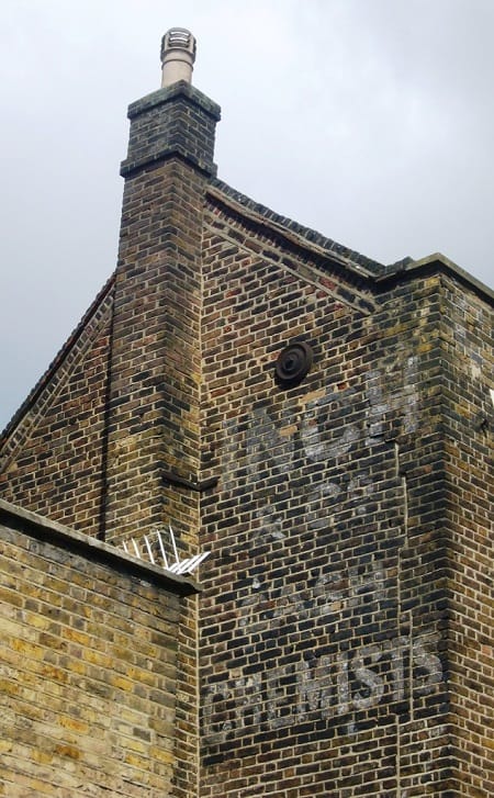 Fading painted advertising on a wall (ghostsign) advertising Inch & Co Cash Chemists