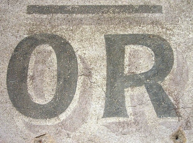 Hand-painted lettering on a wall saying 'Or'