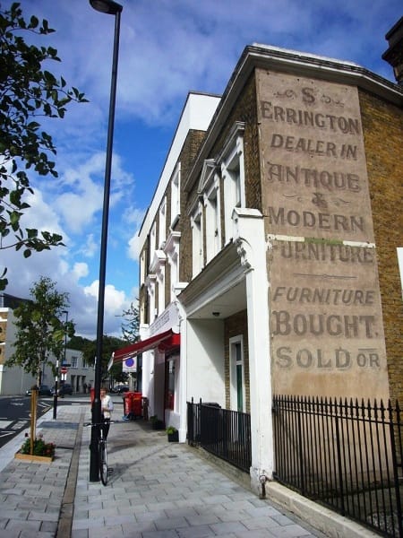 Faded hand-painted lettering on a wall (ghostsign) for S Errington furniture dealer