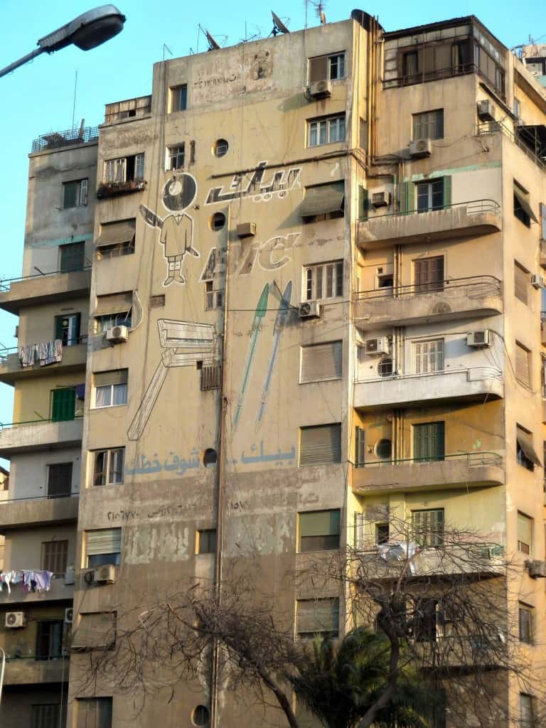 Fading sign painted on a wall advertising Bic pens and razors