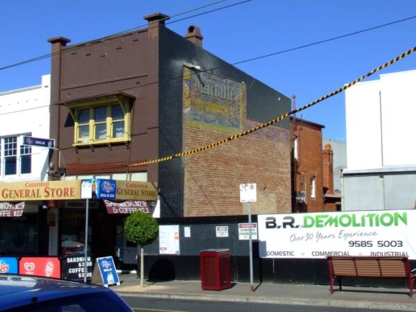 Partial fading painted sign on wall advertising Marmite