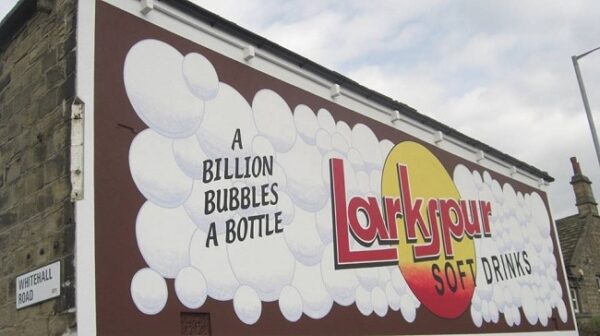 Restored painted sign on a wall for Larkspur Drinks