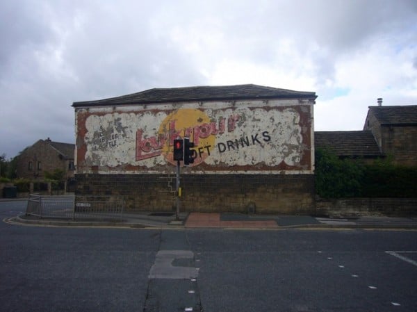 Faded sign on a wall for Larkspur Drinks
