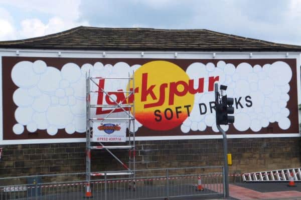 Work in progress on restoration for painted wall sign for Larkspur Drinks