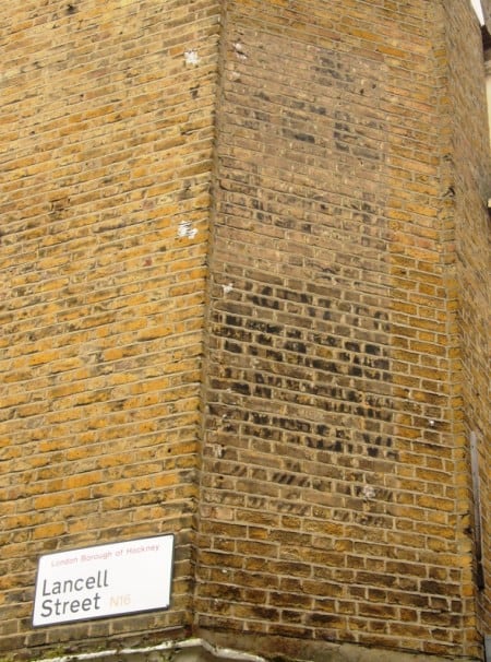 Very faded piece of advertising painted on a wall
