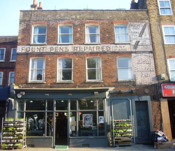Fading sign painted on a wall advertising a fountain pen firm