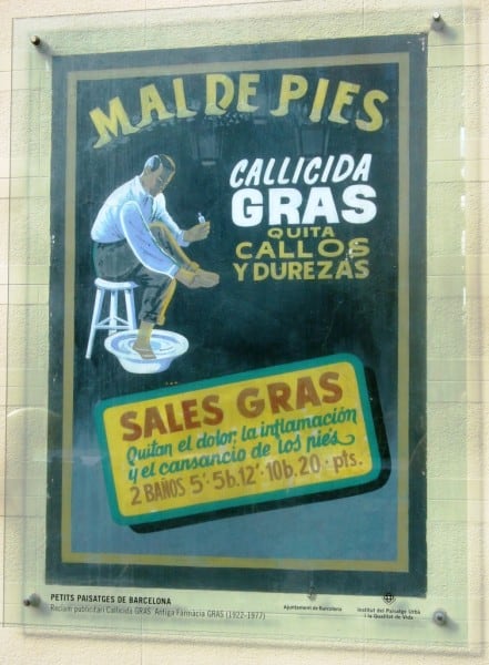 Painted sign on a wall covered by perspex