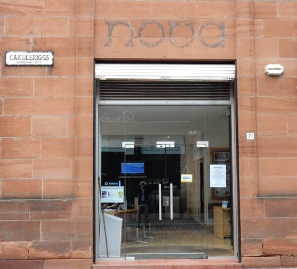 Fading sign for Nova above a shop door