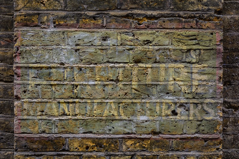 Fading painted sign advertising S. Louis & Co., furniture manufacturers.