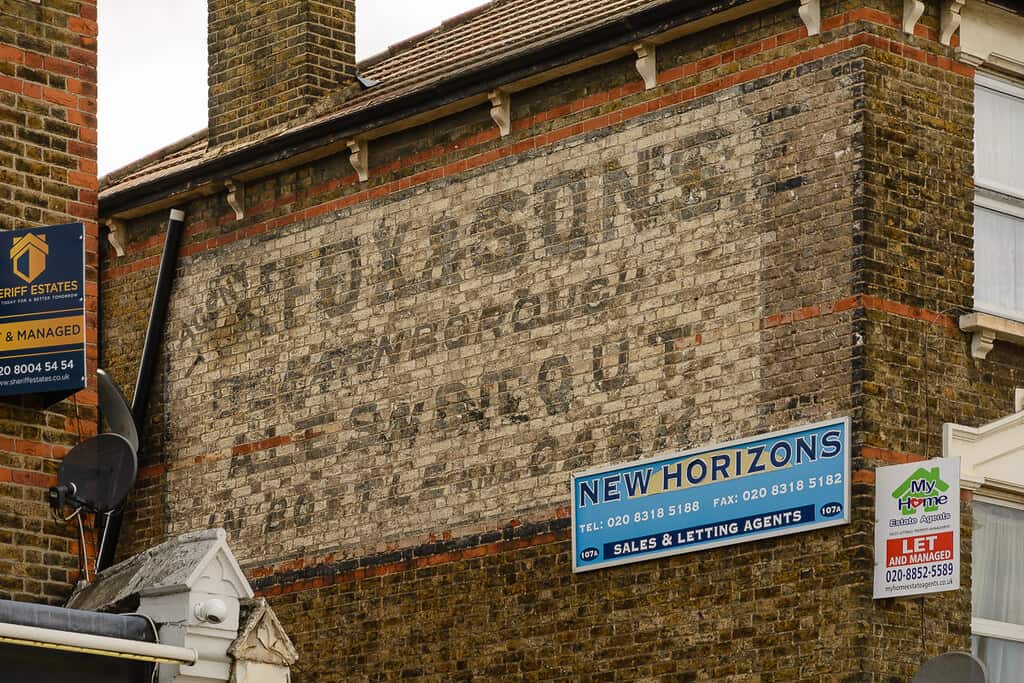 Painted sign on a wall for Fox & Sons ales and stout