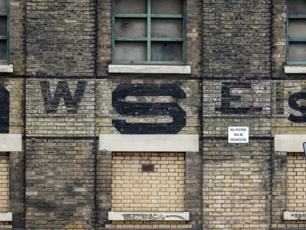 Typographic detail of the painted sign on the wall.